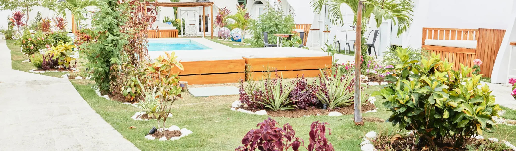 A beautiful garden with a pool designed by a professional garden design company.